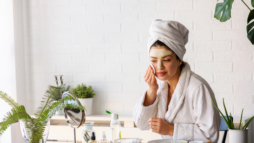 Woman removing facial mask 