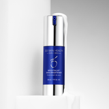 Skincare serum bottle with blue label on a gray background